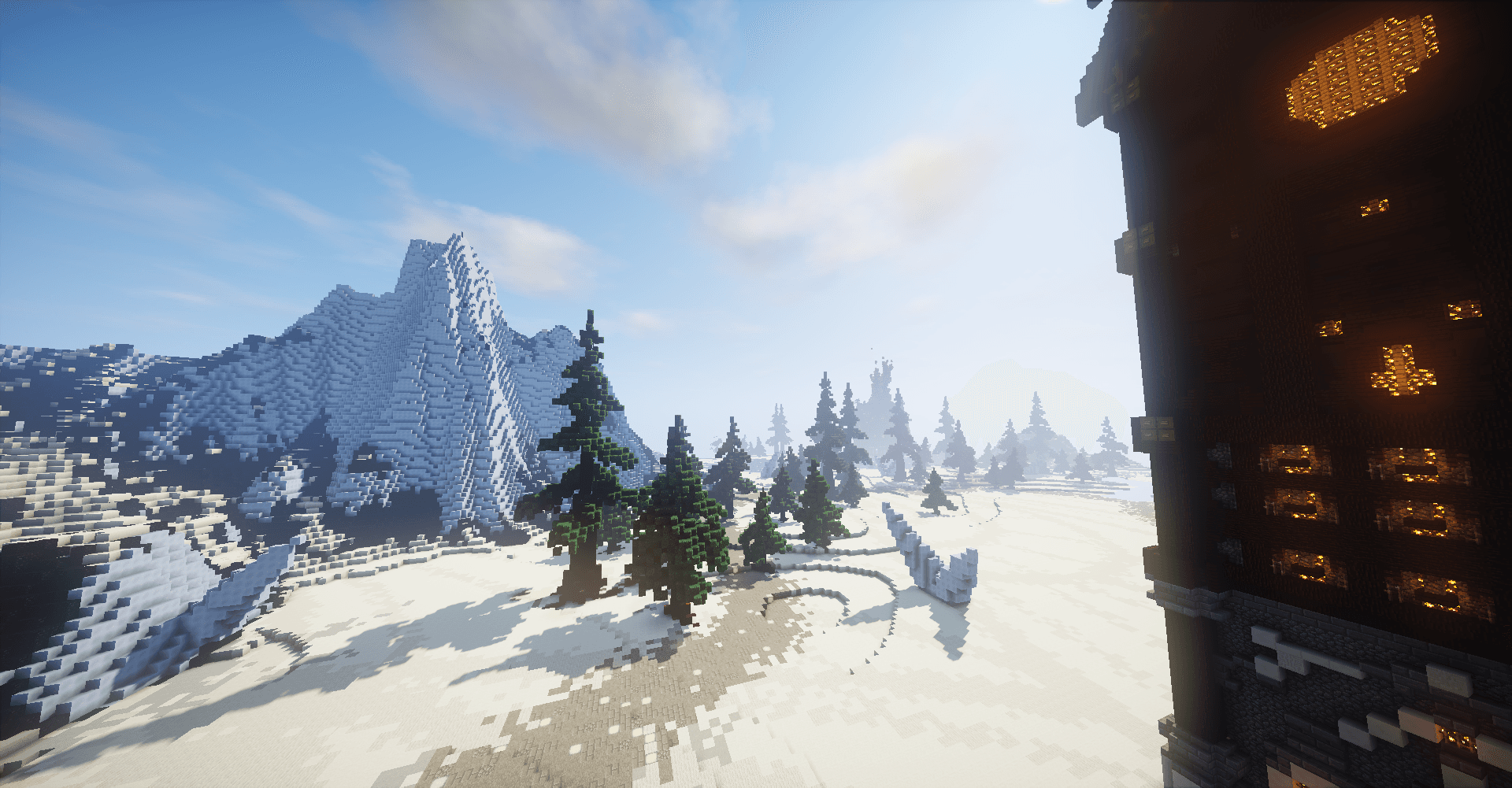 Paysage enneigé du spawn ScandiCraft avec montagnes et sapins